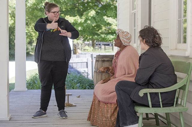 Team member speaking in sign language to guests