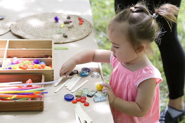 Toddler participating in learn activities with craft materials