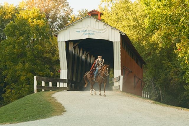 A covered bridge with a guy riding a horse oh wait and the guy had no head making him the headless horseman-clever