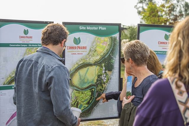 Folks gazing in wonderment at the master plan-it legit looks amazing