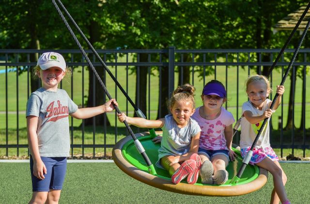 kiddos on a disk swing