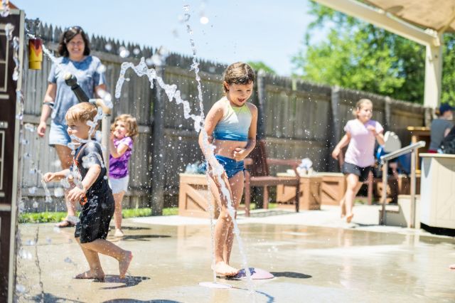 Children playing in little tiny geysers at the splash pad