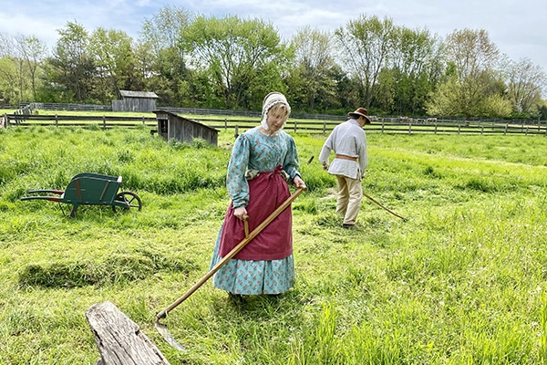 Team working in a field wearing period attire
