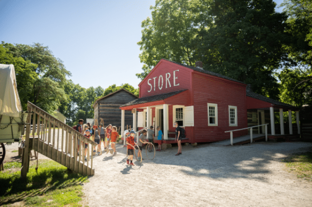 HIstoric store photo and children playing stick and hoop game